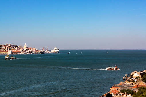 High angle view of ferry boat crossing river from Lisbon city to Lisbon south bay