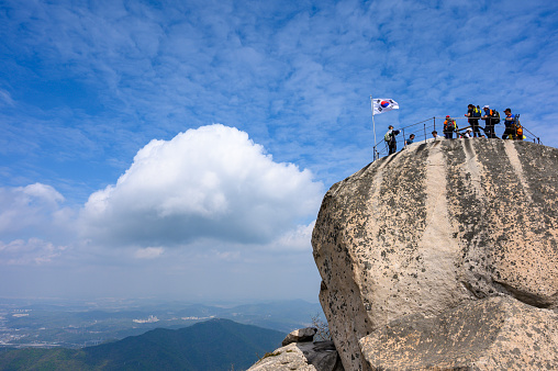 Bukhansan National Park, Seoul, South Korea - April, 27th, 2019: Hikers at the summit of Bukhansan Mountain in Bukhansan National Park