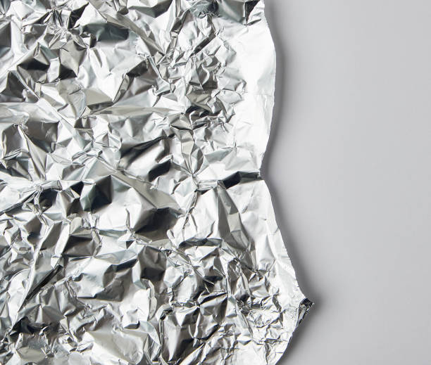 istock ragged edge of silver foil on a white background 1153951017