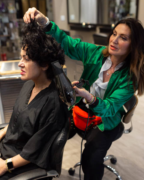 istock Woman cutting client's hair 1153952019