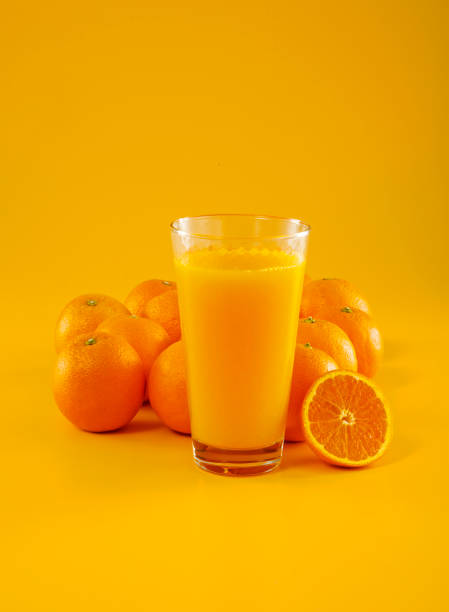 Fresh Orange And Juice Orange and orange juice on orange background. freshly squeezed stock pictures, royalty-free photos & images