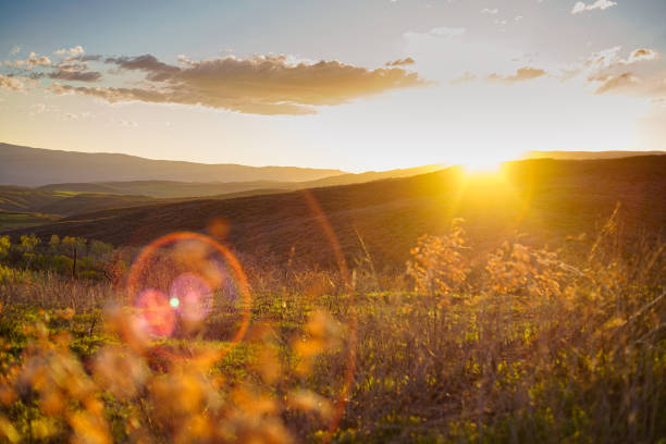 Lens Flare Mountain Sunset Scenic Landscape - Beautiful views with warm sunset light looking toward sunset with interesting sun flare and sunstars.