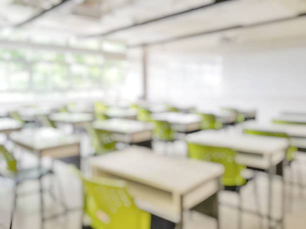istock School classroom in blur background without young student; Blurry view of elementary class room no kid or teacher with chairs and tables in campus. 1153954087