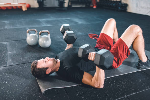 istock Caucasian man doing exercises for the chest using dumbbels 1153954133