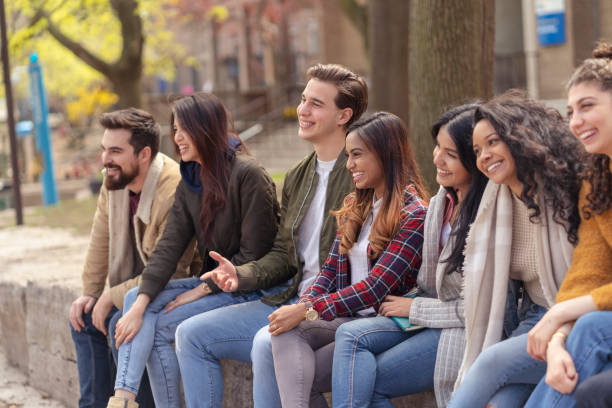 istock Multi-Ethnic Group of University Students Relaxing Outside 1153954528