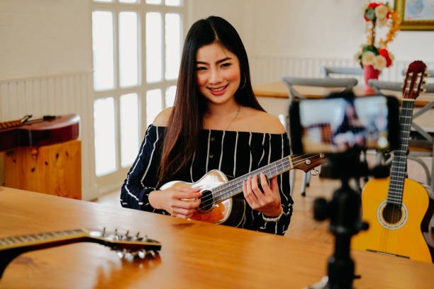 istock blogger live broadcasting music instrument tutorial on social media. vlogger recording online vlog video. 1153955863