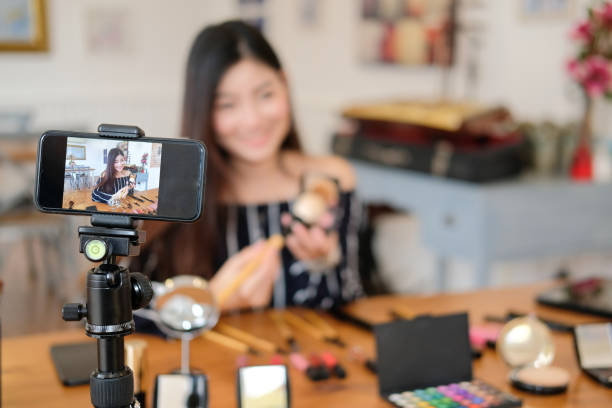 istock beauty blogger live broadcasting cosmetic makeup tutorial on social media. 1153955883