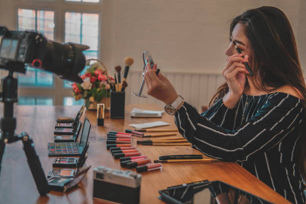 istock beauty blogger live broadcasting cosmetic makeup tutorial on social media. 1153955887