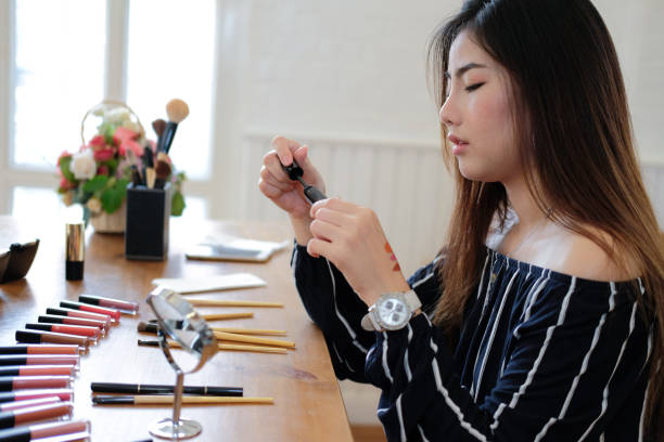 istock asian woman applying makeup cosmetic 1153955892