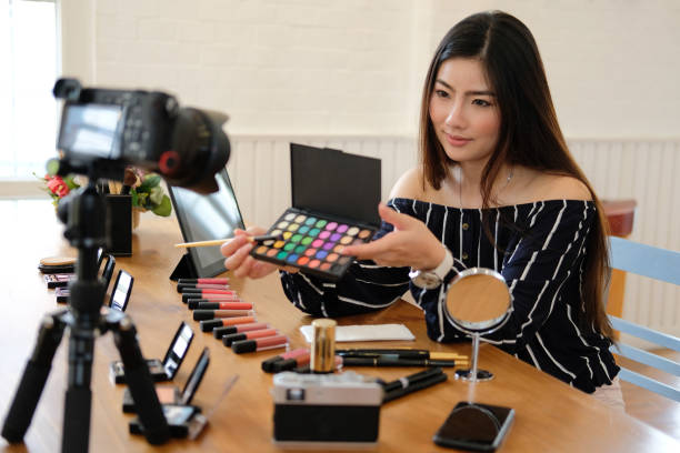 istock beauty blogger live broadcasting cosmetic makeup tutorial on social media. 1153955898