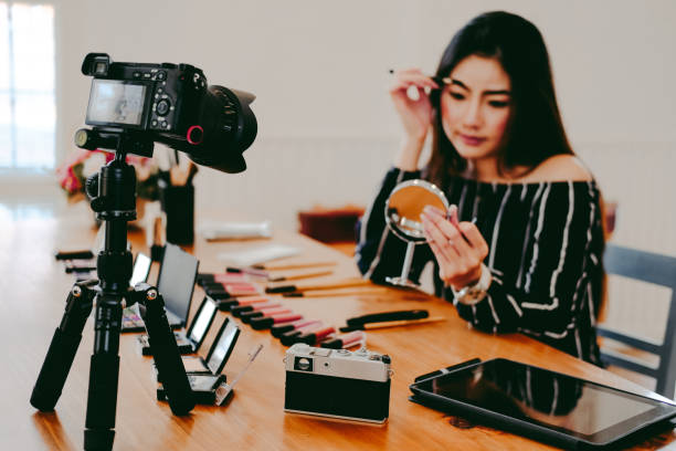 istock beauty blogger live broadcasting cosmetic makeup tutorial on social media. 1153955901