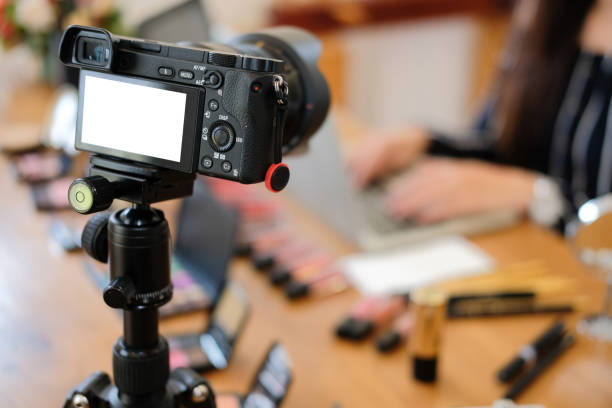 istock beauty blogger live broadcasting cosmetic makeup tutorial on social media. 1153955903