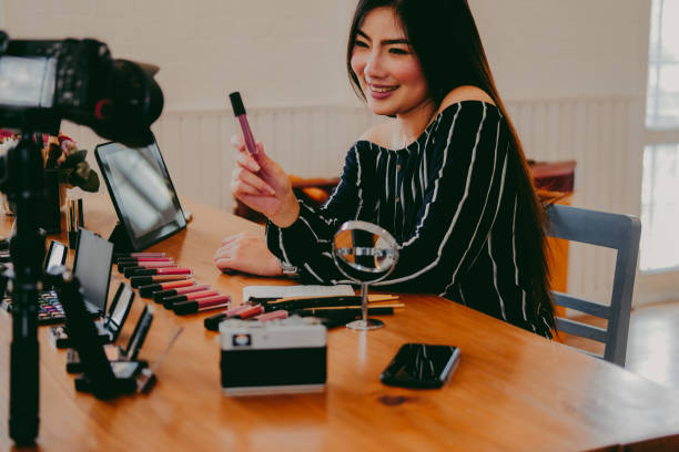 istock beauty blogger live broadcasting cosmetic makeup tutorial on social media. 1153955907