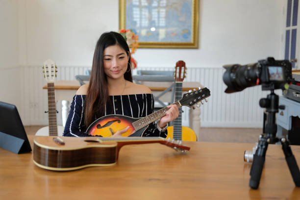 istock blogger live broadcasting music instrument tutorial on social media. vlogger recording online vlog video. 1153955915