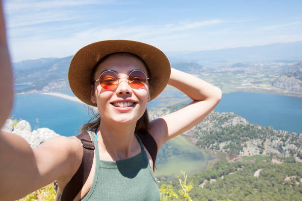 istock beautiful woman hiker at the peak 1153959032