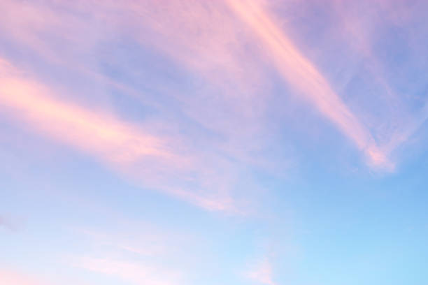 istock pretty pastel colour sky pink purple blue with fluffy cloud on beach 1153959165