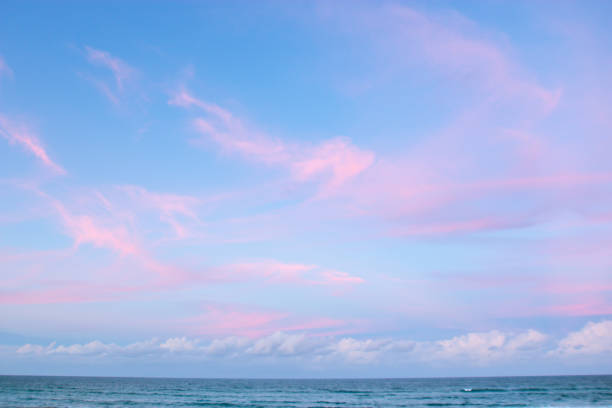 pretty pastel colour sky pink purple blue with fluffy cloud on beach with white sand Australia Gold Coast