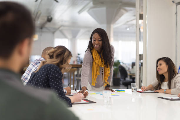 istock Female CEO leads a team meeting 1153960154