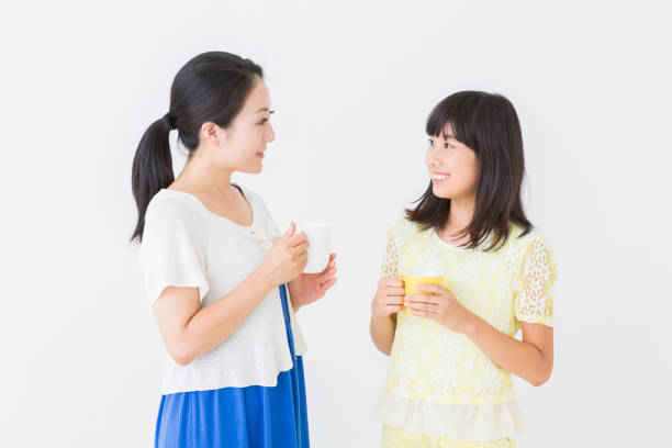 asian parent and daughter who is relaxed,drink,