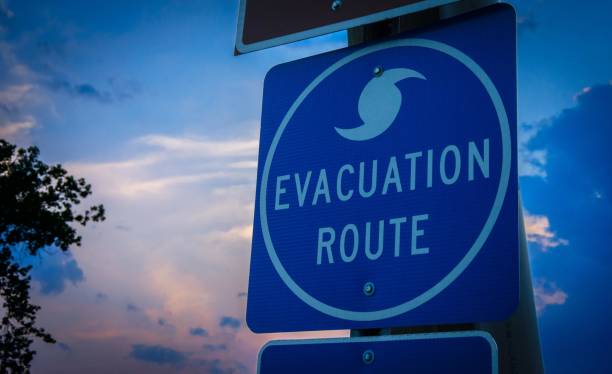 Evacuation Route Sign A highway road sign directs weather evacuees to safety. emergency shelter photos stock pictures, royalty-free photos & images