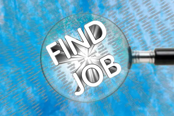Inscription FIND JOB through a magnifying glass on an abstract background. Job search concept.