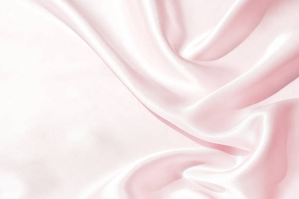istock Charming smooth satin and silk pink fabric for backgrounds. Elegant abstract upholstery use for holidays 1153965636