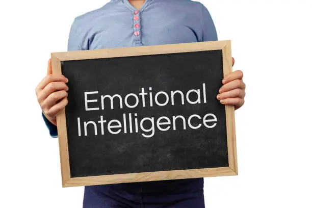 Emotional Intelligence issue depicted with child holding blackboard with text