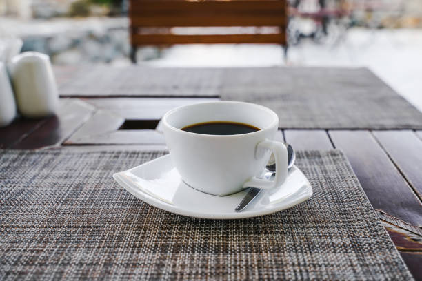 istock white ceramic cup of hot coffee on desk in morning 1153970419