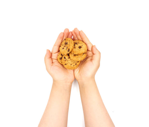 istock Female hand holding Biscuits on a white background 1153972483