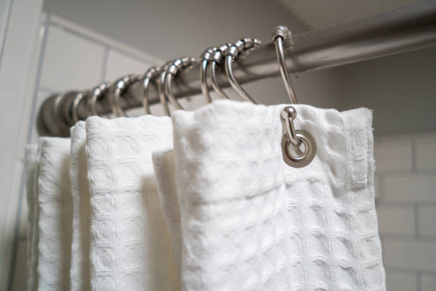 Decorative luxurious shower curtain on hooks. stock photo