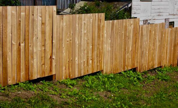istock Stair Step Fence On Uneven Ground 1153983593