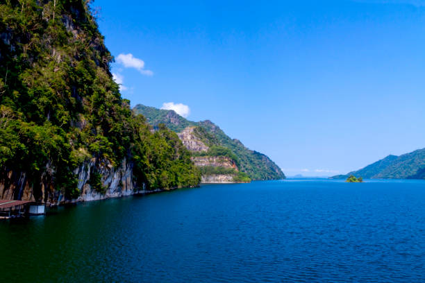 istock Waterproof dam with cliff and blue sky water is emerald 1153985013