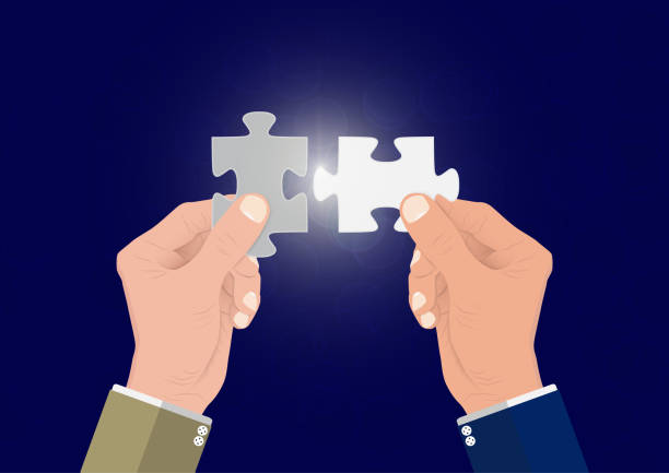 istock Businessman's hand connecting two puzzle pieces jigsaw together,successful solution business concept vector illustration 1153985743