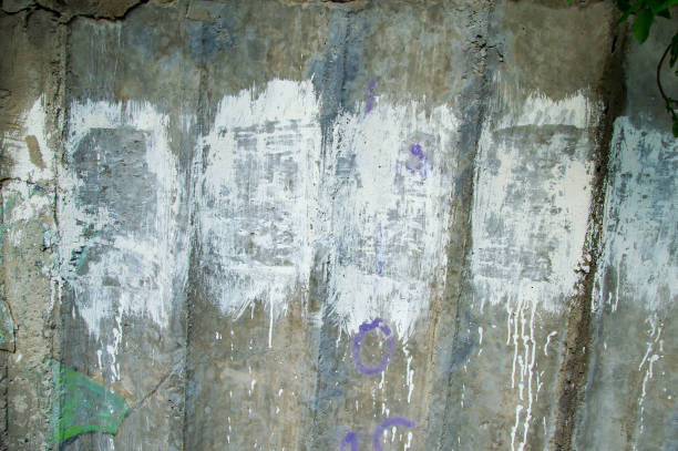 istock Texture of a concrete wall painted with white paint. 1153987131