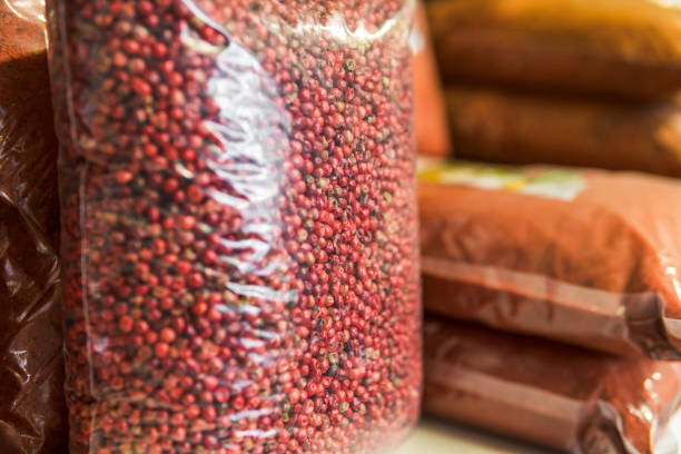 istock pink pepper seeds in a package on the store shelf 1153987961