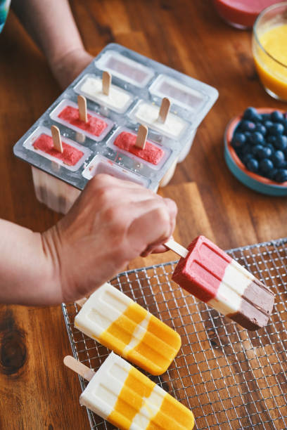 istock Preparing Mango, Strawberry, Chocolate, Yogurt Ice Cream on Stick 1153990960