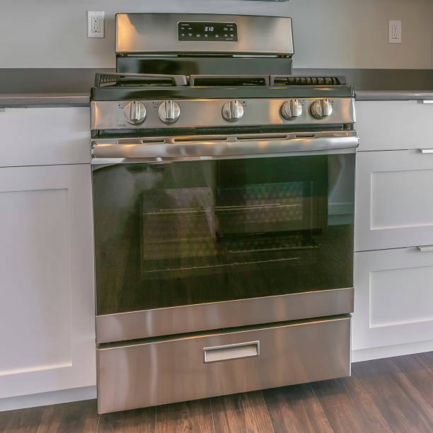 istock Square Range and wall mounted microwave inside the modern kitchen of a new house 1153992727