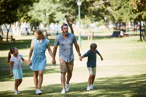 Shot of a happy young family going for a walk in the park
