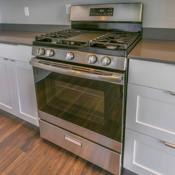istock Frame Square Range and wall mounted microwave inside the kitchen with brown wooden floor 1153995165