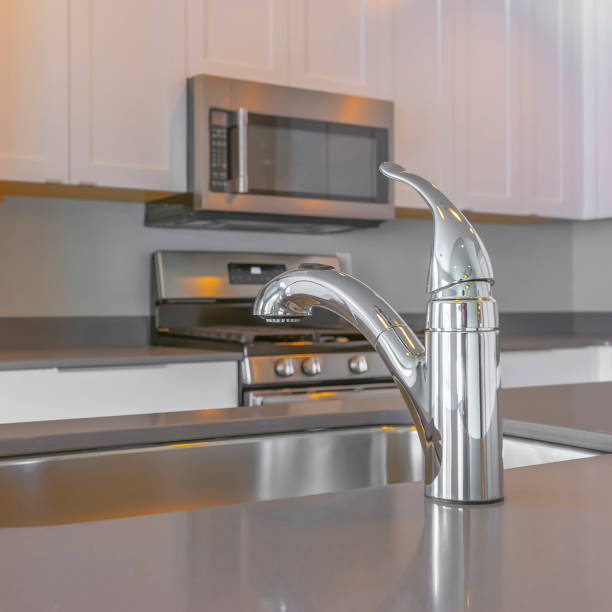 istock Frame Square Modern kitchen interior with faucet and sink on the glossy countertop 1153995195