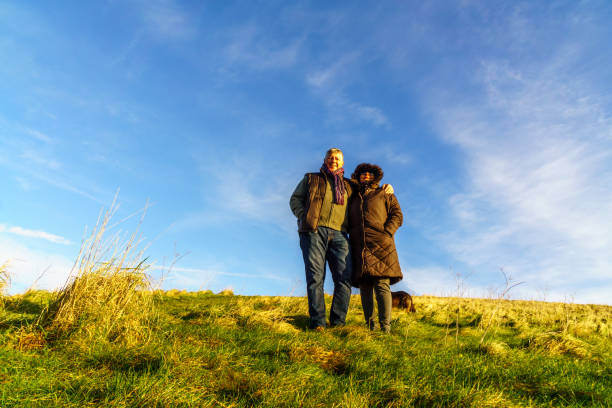istock Senior couple walking on countryside path in winter 1153997490