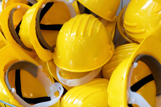 istock construction industry - group of yellow safety helmets 1153997552