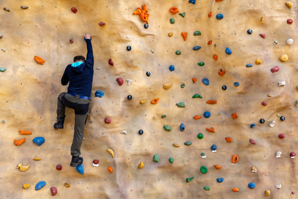 istock bouldering - man climbing on artificial rock wall 1153997561