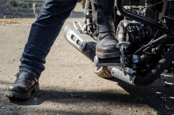 istock foot bikers in motorcycle boots sitting on a motorcycle 1153997623