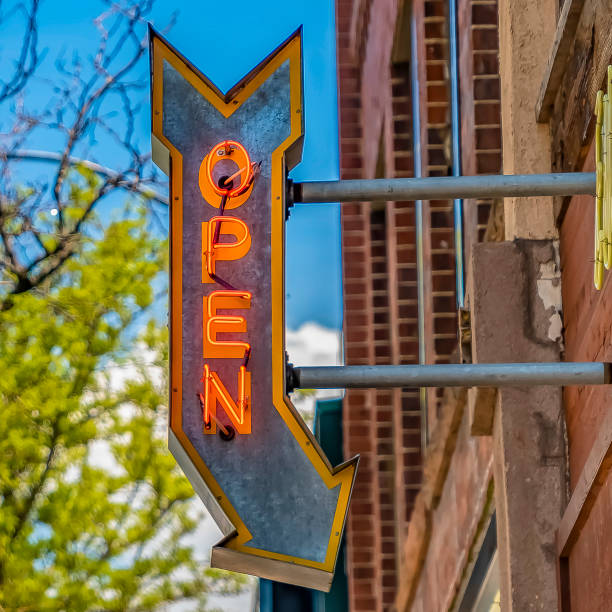 istock Frame Square Lamp post and building with an Open sign against vibrant trees on a sunny day 1153997755