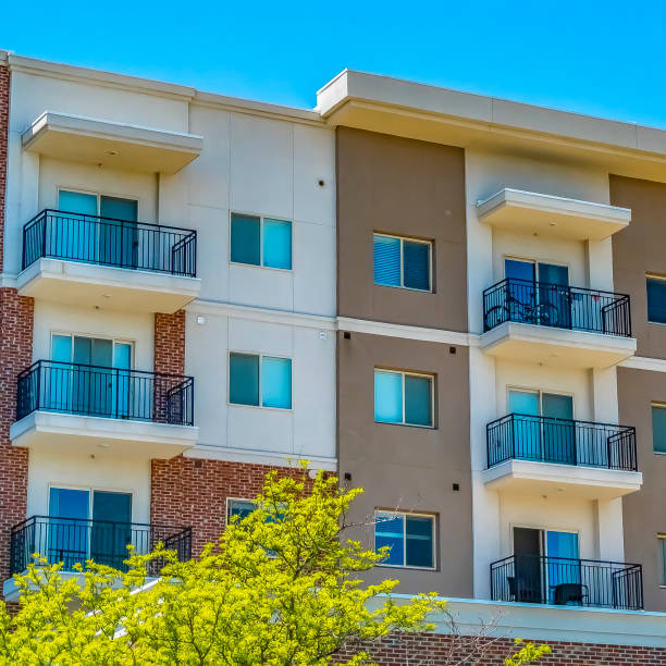 istock Square Residential building featuring red brick exterior wall and small balconies 1153997757