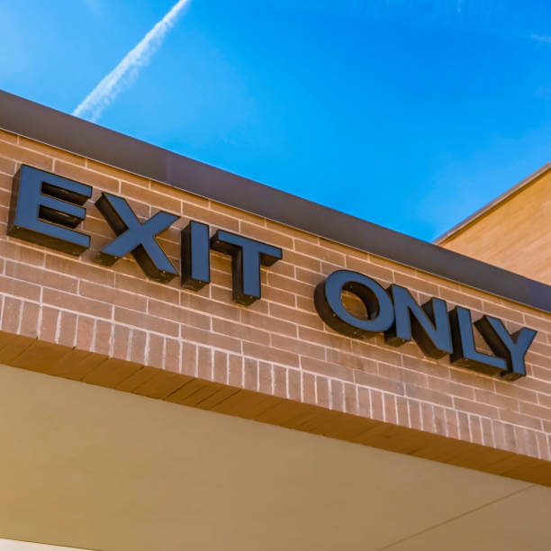 istock Frame Square Exit only sign on the exterior brick wall of a building with shiny window 1153997776