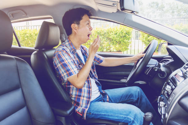 istock Tired young asia man driving his car 1153997925