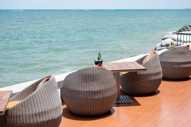 istock Modern weave chairs with wooden table with tropical sea 1154001687