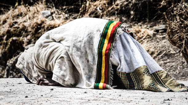 istock pilgrim man in traditional white clothes praying 1154001921